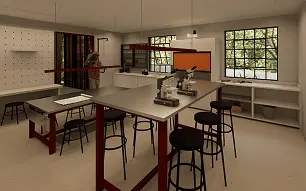 Vista interna de laboratório. Mesas com diferentes alturas com estrutura metálica e bancos ao redor no centro.